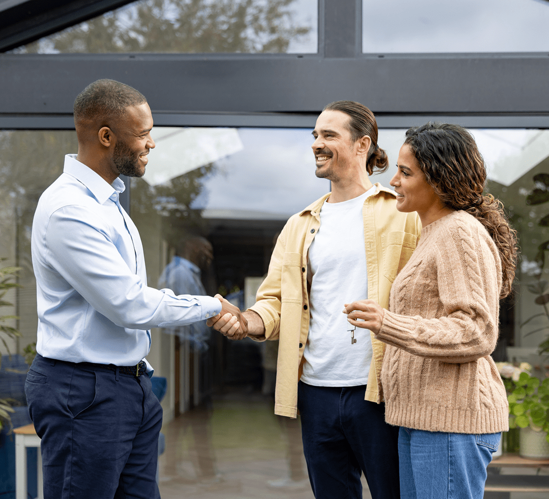 Friendly handshake between three people