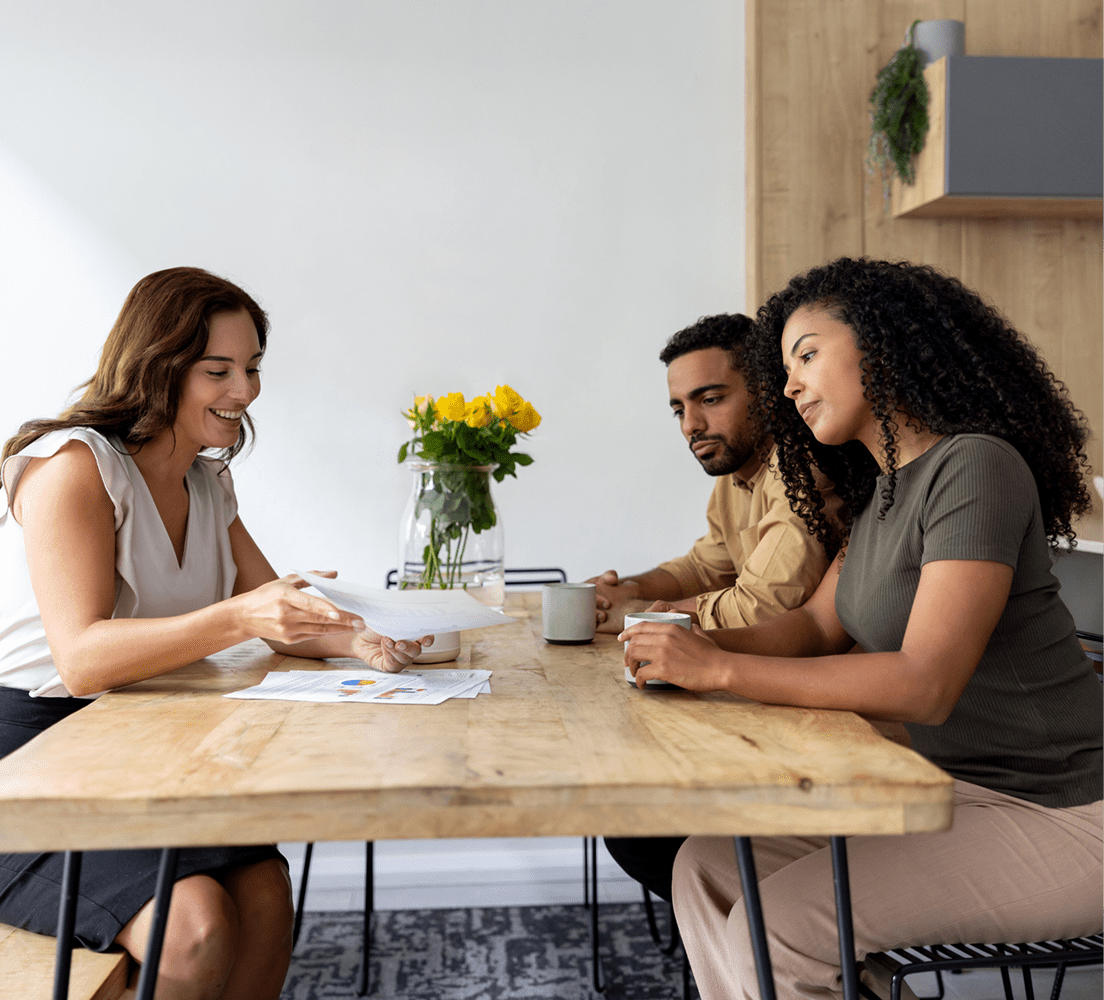 People discussing paperwork at table