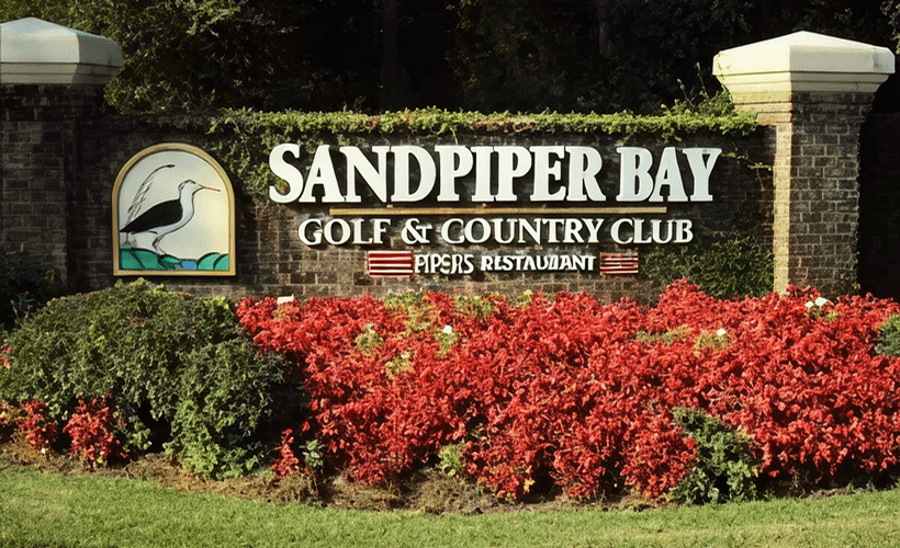 Sandpiper Bay entrance sign with flowers