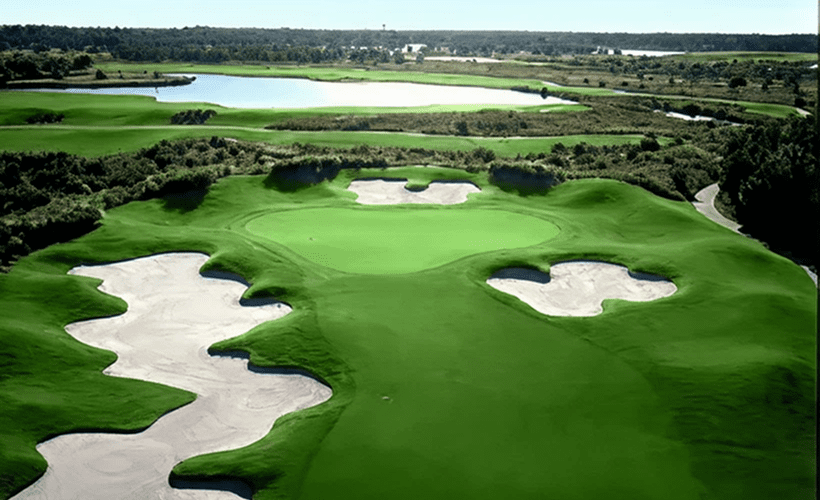 Golf course with sand traps and lake